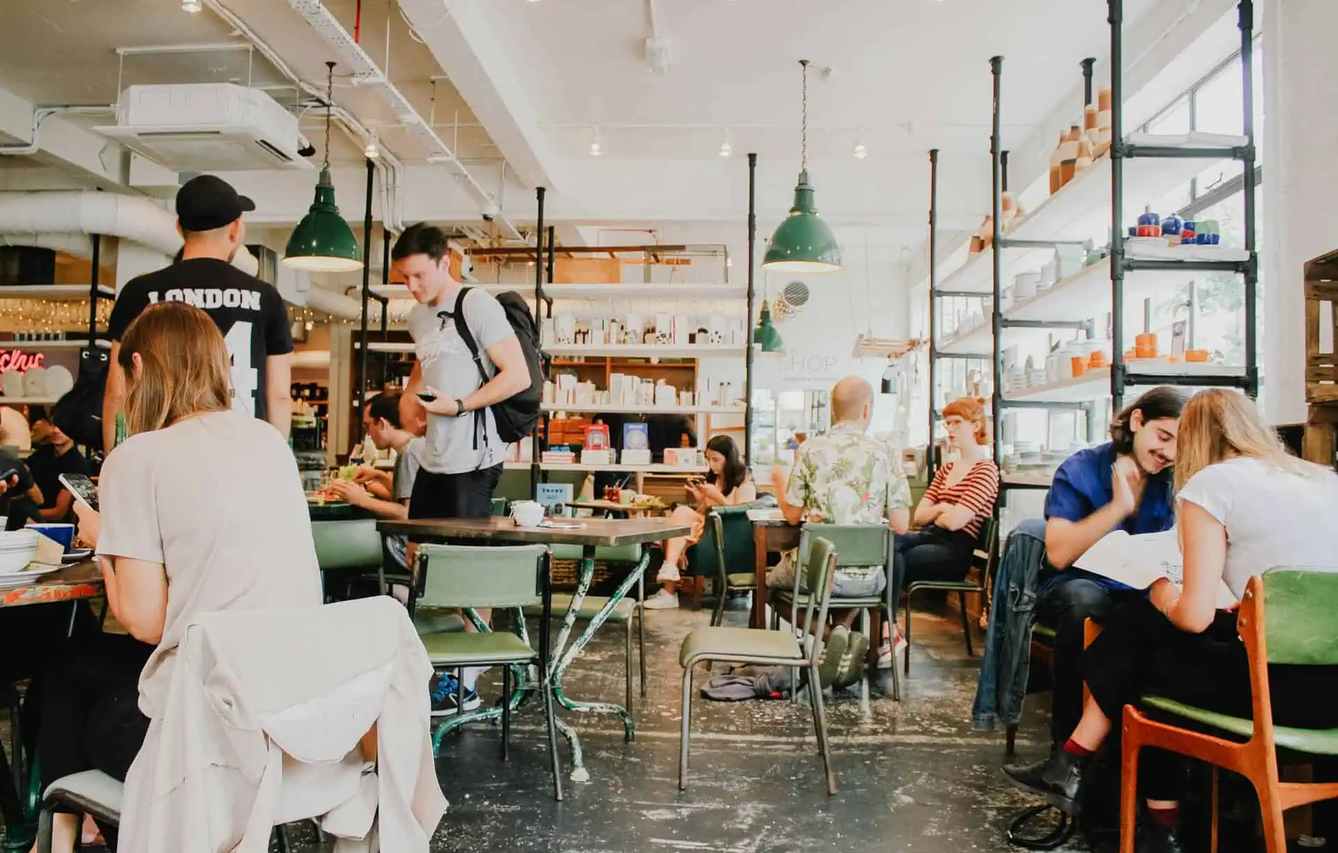 Customers interacting in a local café, representing community engagement and visibility achieved through Google Business Profile optimization.
